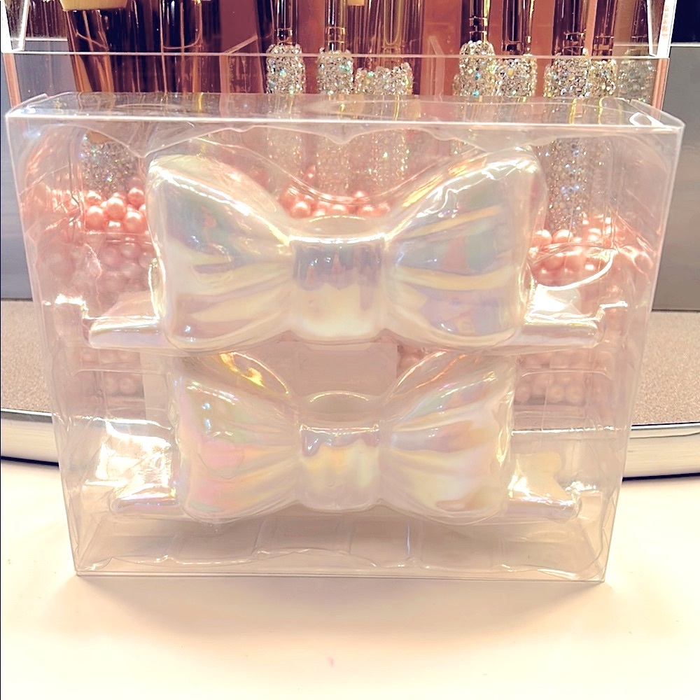 Iridescent bow ceramic candle holders.